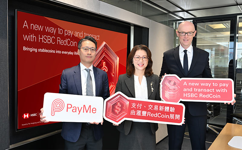 Maggie Ng, Lawrence Li and John O'Neill of HSBC seated at a table with red gift boxes, with a screen showing the PayMe by HSBC logo behind them
